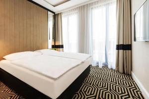 Postel nebo postele na pokoji v ubytování VacationClub - Baltic Park Fort Apartament G.506