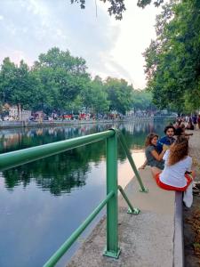 a group of people sitting next to a body of water at Studio avec wifi a Paris in Paris