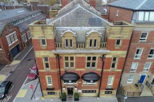 an aerial view of an old brick building with a balcony at The Old Post Office Warrington by Deuce Hotels in Warrington