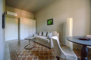 a living room with a couch and a table at Palazzo Froussard B&B and Living in Lucca