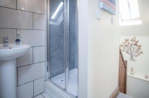 a bathroom with a shower and a sink at The Old School Cottage Ship Farm - 1 Bedroom - Rhossili in Rhossili +29 photos