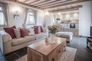 a living room with a couch and a coffee table at Fferm-Llong Cottage Ship Farm - 2 Bedroom -Rhossili in Rhossili