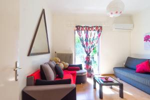 a living room with a teddy bear sitting on a red couch at Mema's Tranquil Apartment in Patra in Patra