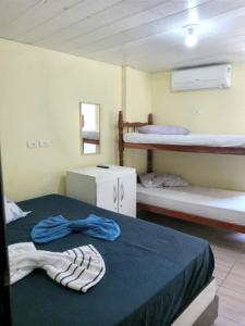 a room with two beds and two bunk beds at POUSADA LELÊ CONVENÇÕES in Recife