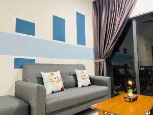 a living room with a gray couch and a table at C180 Cheras Traders Square Balakong As Home in Cheras