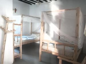 Postel nebo postele na pokoji v ubytování New Iddi Villa