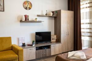 a living room with a entertainment center with a television at Luxor Apartment in Velingrad