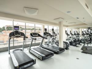 a gym with a bunch of cardio machines at Falkensteiner Hotel Bratislava in Bratislava