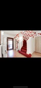 a living room with a red carpet and stairs at Mansion 8 bedrooms in Private Gated Ave Huge garden Hot tub FREE SAUNA up to 23 in Luton +76 photos