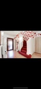 a living room with a red carpet and stairs at Beautiful mansion in private gated Rd Hot tub FREE SAUNA in Luton