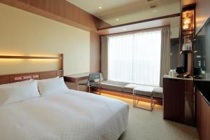 Postel nebo postele na pokoji v ubytování Candeo Hotel Utsunomiya