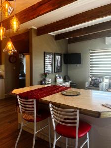 a kitchen with a table and chairs in a room at Eagleview Guesthouse in Hermanus