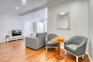 a living room with two chairs and a table at Vila Camacho Guest House in Funchal