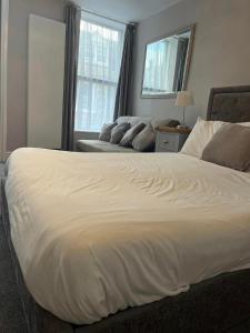 Four Seasons Hotel في آبريستويث: سرير أبيض كبير في غرفة نوم مع نافذة