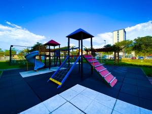 a playground with a slide and slidesktop at Hotel Rainha do Brasil in Aparecida