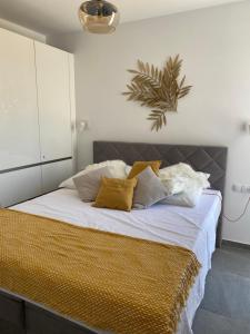 a bedroom with a large bed with white walls at Penthouse Maus in Trogir
