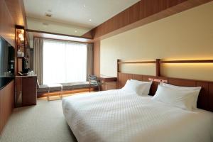 Postel nebo postele na pokoji v ubytování Candeo Hotel Utsunomiya