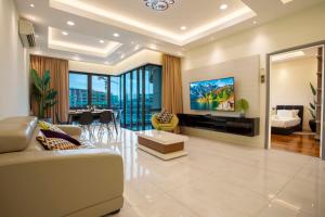 a living room with a couch and a tv at AJ Suites @ Loft Imago KK in Kota Kinabalu