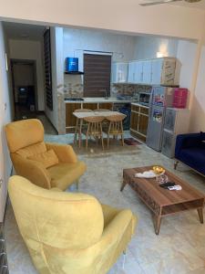 a living room with a couch chairs and a table at Dreams Apartments شقق الاحلام in Baghdad