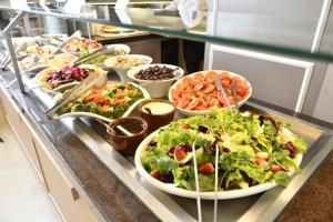 a buffet line with many different salads and bowls of food at Hotel Rainha do Brasil in Aparecida +139 photos