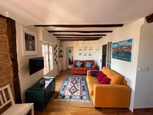 a living room with two couches and a tv at IZARO EYE BERMEO by Urdaibai Rentals in Bermeo