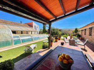 a table with a bowl of fruit on a patio at Casas Rurales Venta Seca complejo Rural para 24-28 plazass in Mazarrón