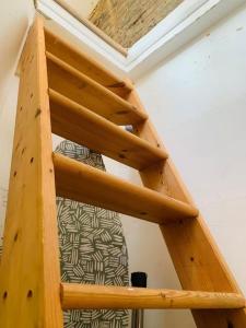 a wooden ladder in a room with a bed at Funky 2 Bedroom Apartment In Town Centre in Hastings