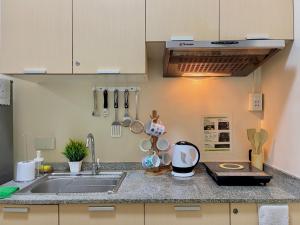 a kitchen with a sink and a counter top at Paseo Verde Condominium 1 Bedroom for 6 pax in Manila