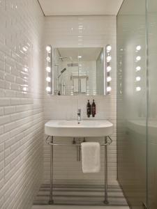 a white bathroom with a sink and a mirror at Be Mate Casa Di Bava in Istanbul