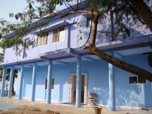 a blue building with a balcony on top of it at Tara Guest House in Bodh Gaya