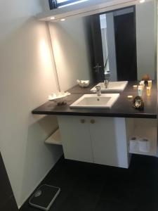 a bathroom with a sink and a mirror at Haamaire in Bora Bora