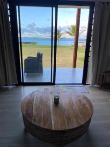 a coffee table in a room with a view of the ocean at Haamaire in Bora Bora