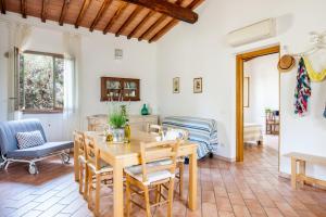 a living room with a wooden table and chairs at Agriturismo Fontetrilla in Orbetello