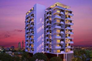 a rendering of a tall apartment building at dusk at Apartment with Pool & Gym in Colombo
