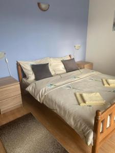 a bedroom with a large bed with two lamps on it at Natura A1 in Medulin