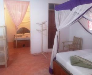 Postel nebo postele na pokoji v ubytování New Iddi Villa