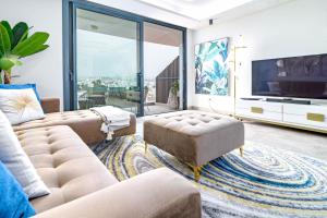 a living room with two couches and a television at INF25E- Tastefully furnished flat, Estepona center in Estepona