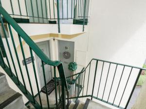 a staircase leading to a door with a potted plant at Bowness Hideaway in Windermere