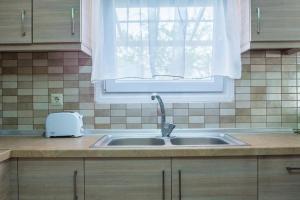 a kitchen counter with a sink and a window at Diogenis villa in Vourvourou
