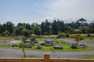 a park with rocks and a picnic table and a playground at The Buzzard - 6 Person Family Glamping Cabin in Dungarvan