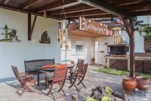 a patio with a table and chairs and a fireplace at Diogenis villa in Vourvourou