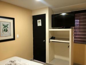 Hotel Ecosuite Quibdó客房内的一张或多张床位