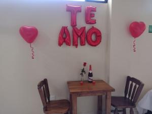 a room with a table and two hearts and the word i love at HOTEL BS in Nemocón +69 photos