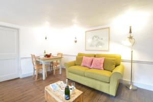 a living room with a couch and a table at Tiger Villa, Aldeburgh in Aldeburgh