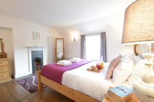 a bedroom with a large bed and a fireplace at Tiger Villa, Aldeburgh in Aldeburgh