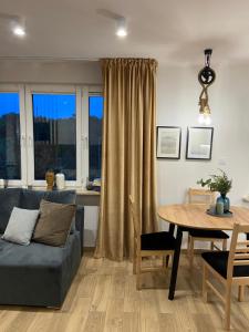 a living room with a couch and a table at Apartament La Playa! Najlepsza lokalizacja! in Hel +10 photos