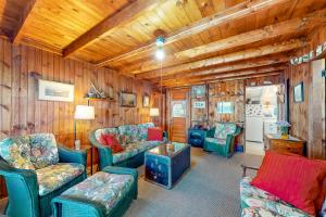 a living room with wooden walls and chairs and a table at Lake Winnipesaukee's Charmer in Alton Bay