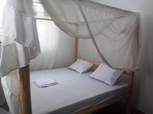 Postel nebo postele na pokoji v ubytování New Iddi Villa