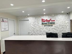 an office with a white counter with a sign on the wall at Red Roof Inn Georgetown, KY in Georgetown