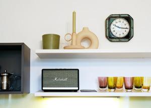 a shelf with a clock and a laptop on it at Stilvolles Apartment in zentraler Lage in Graz